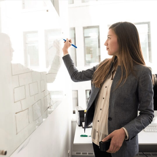 Woman writing on whiteboard